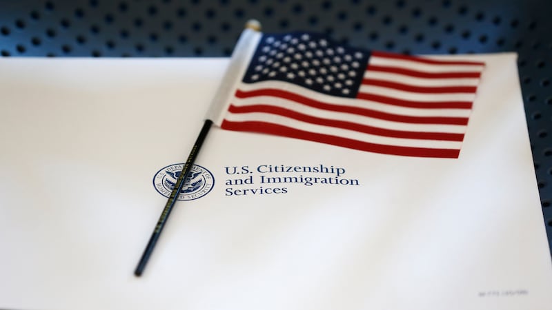 FILE - An information packet and an American flag are placed on a chair at the U.S....